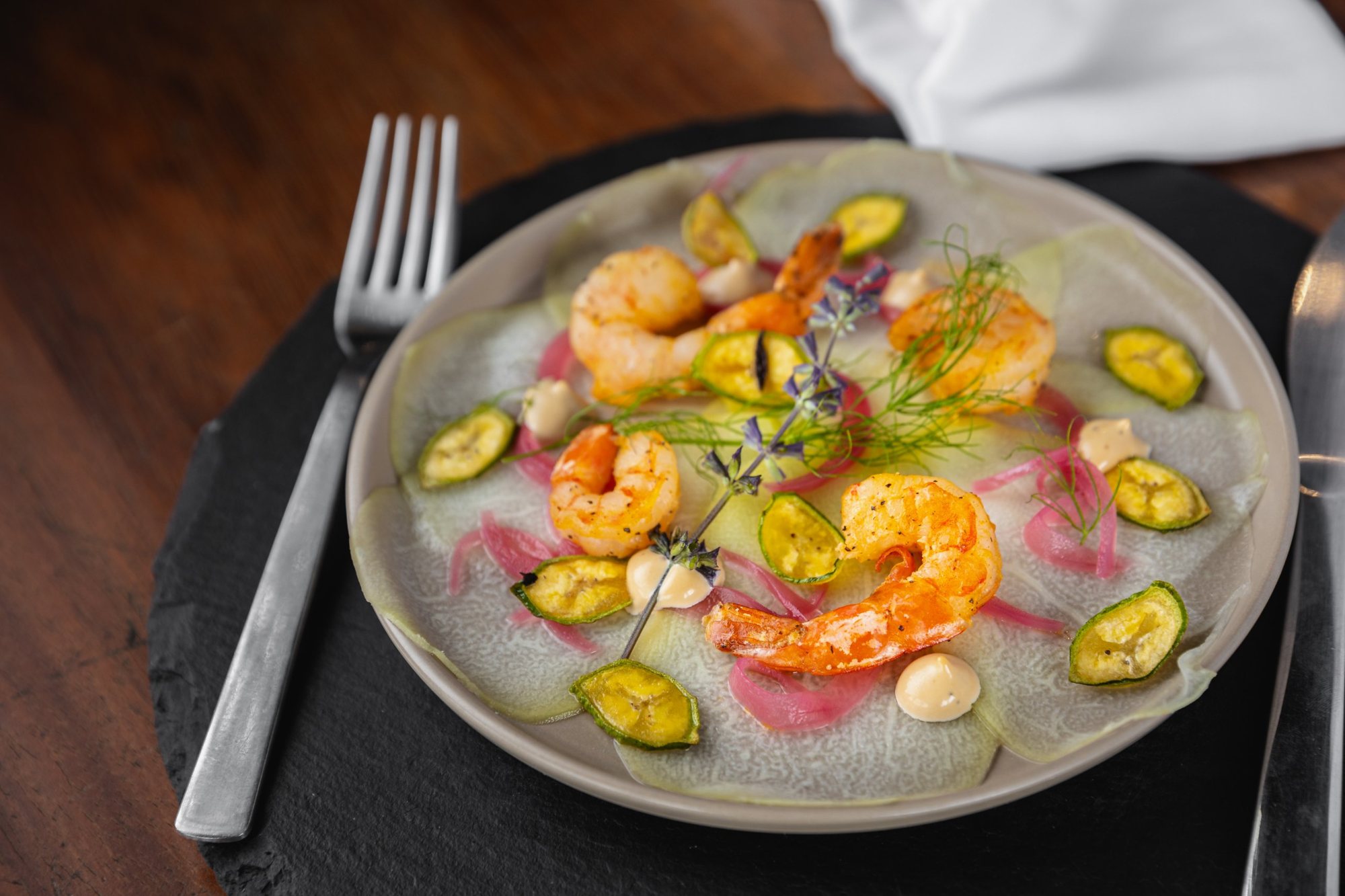 Grilled shrimp with plantain chips and pickled red onion